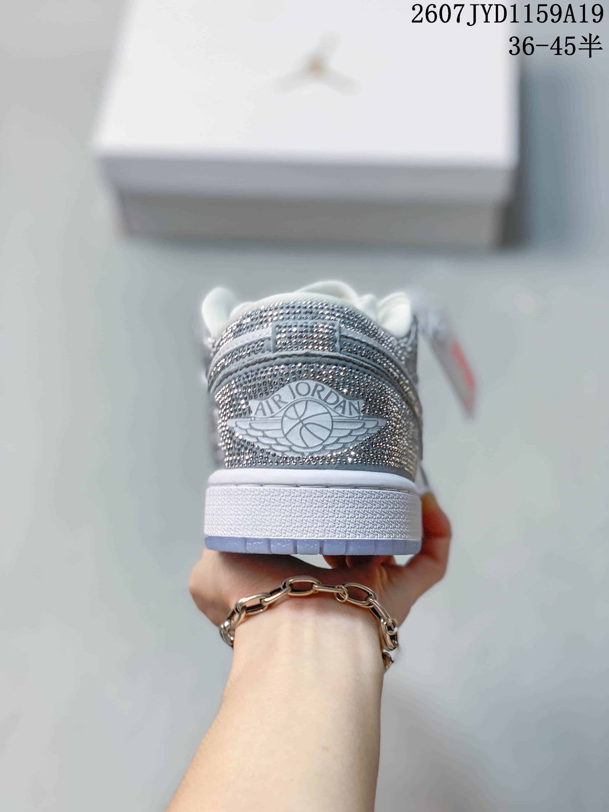 Rear view of the sneaker showing the Air Jordan winged basketball logo on a silver decorative heel panel.