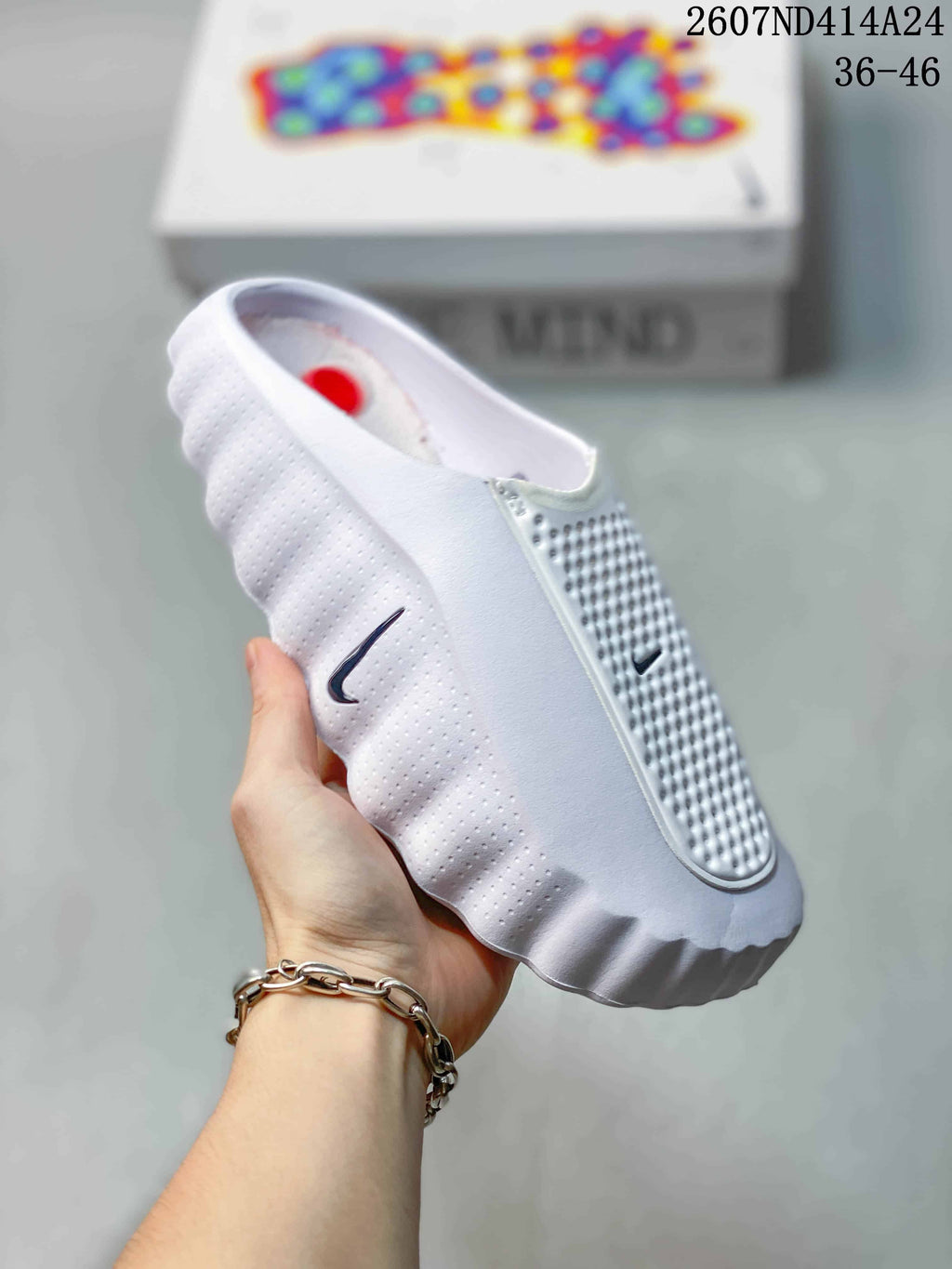 Angled side view of the white slide showing the Nike side logo, perforated upper and sculpted outsole.