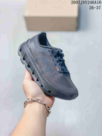 Black On Cloudstratus 3 kids running shoe with a tonal side logo and rugged segmented outsole.