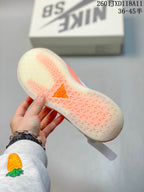 Close view of the translucent patterned outsole with orange sections on a Nike SB PS8 sneaker.