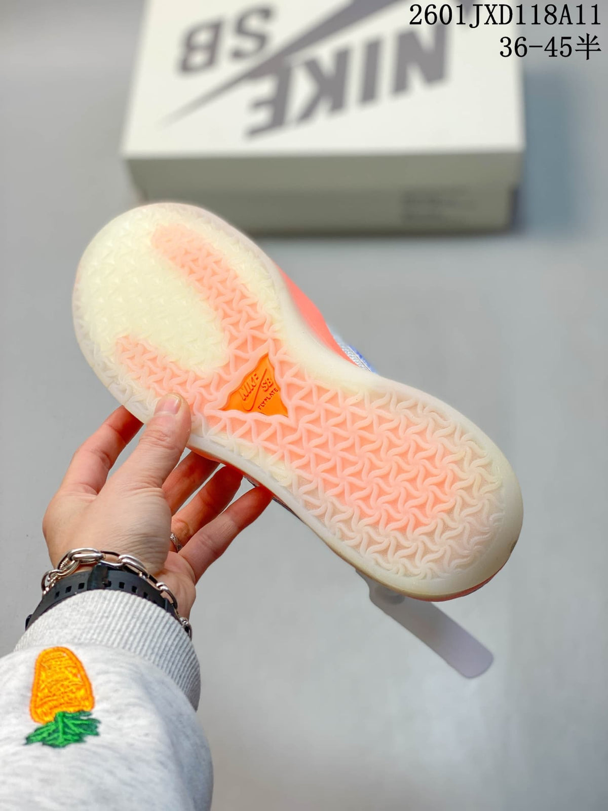 Close view of the translucent patterned outsole with orange sections on a Nike SB PS8 sneaker.