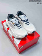 White and black adidas Hyperboost ATR sneakers shown on a red shoebox.