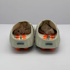 Rear view of the pair showing the open heel design and rectangular heel details.
