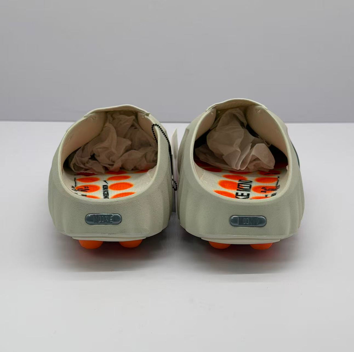 Rear view of the pair showing the open heel design and rectangular heel details.