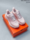 Pair of pink Nike Air Pegasus Premium sneakers displayed on an orange shoebox.
