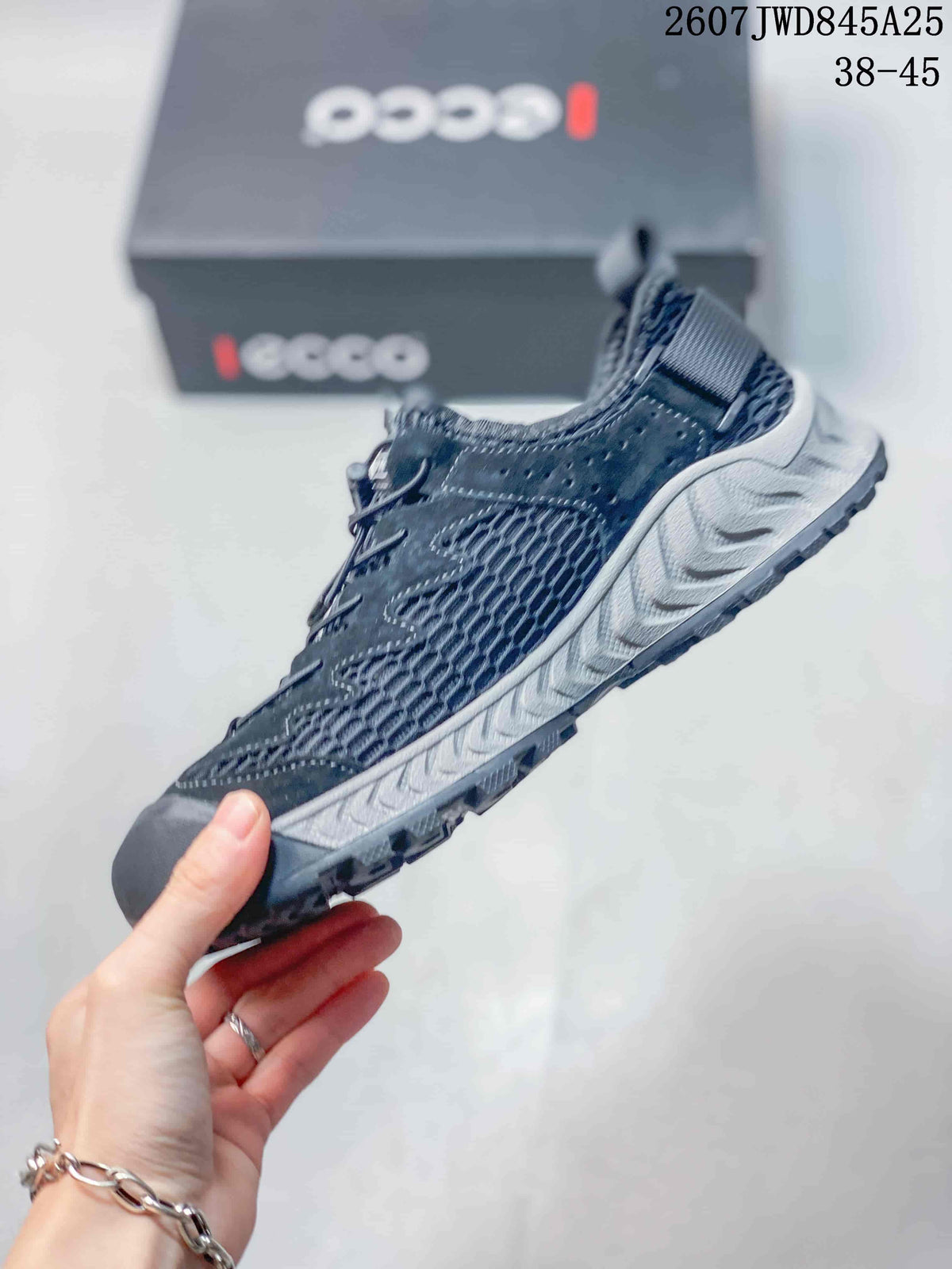 Side profile of the dark ECCO sneaker showing breathable mesh panels, structured overlays, and the rugged outsole.