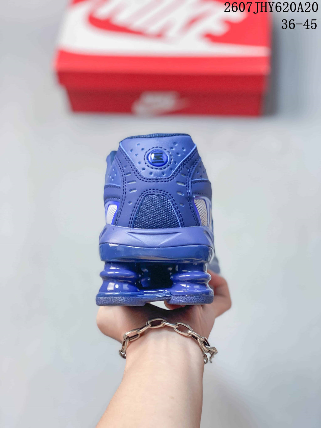 Rear view of the blue sneaker showing the padded collar, heel structure and segmented cushioning sole.