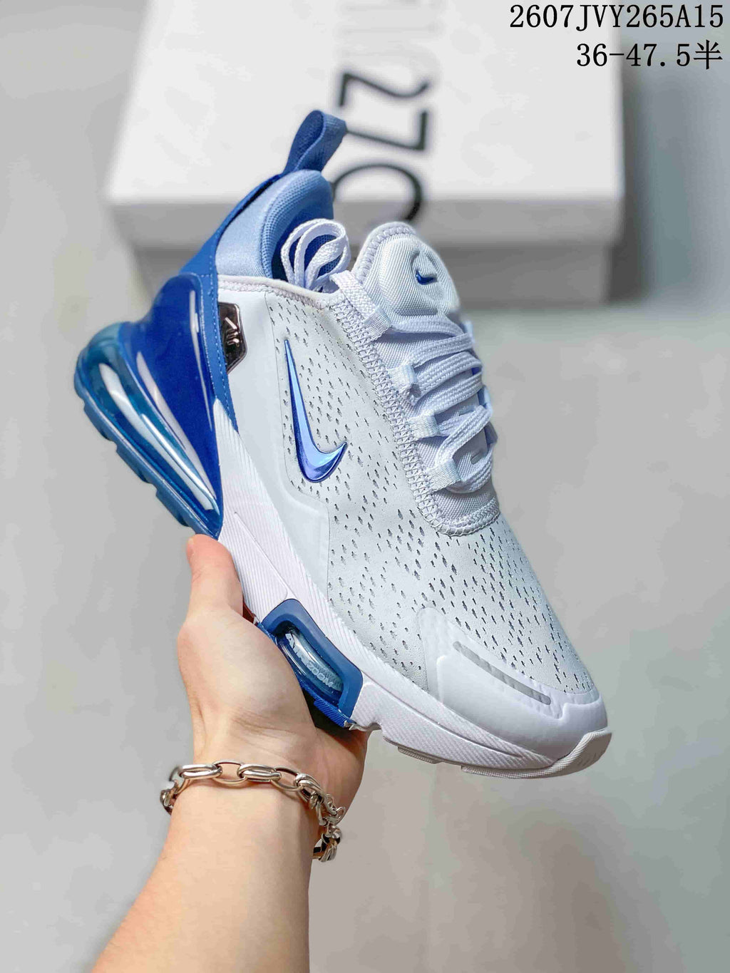 Angled side view showing the white and blue upper, Nike Swoosh, laces, and heel cushioning unit.