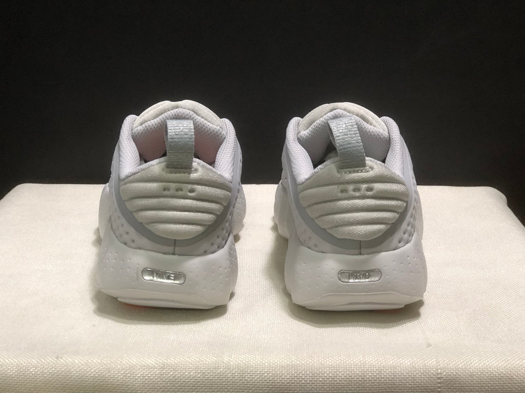 Rear view of the white sneakers showing padded heel collars, pull tabs and heel details.