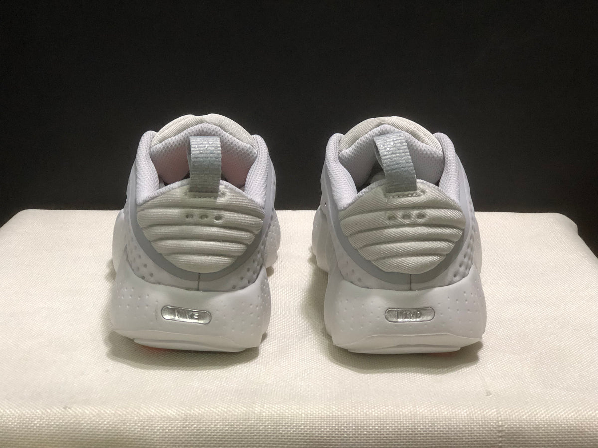 Rear view of the white sneakers showing padded heel collars, pull tabs and heel details.