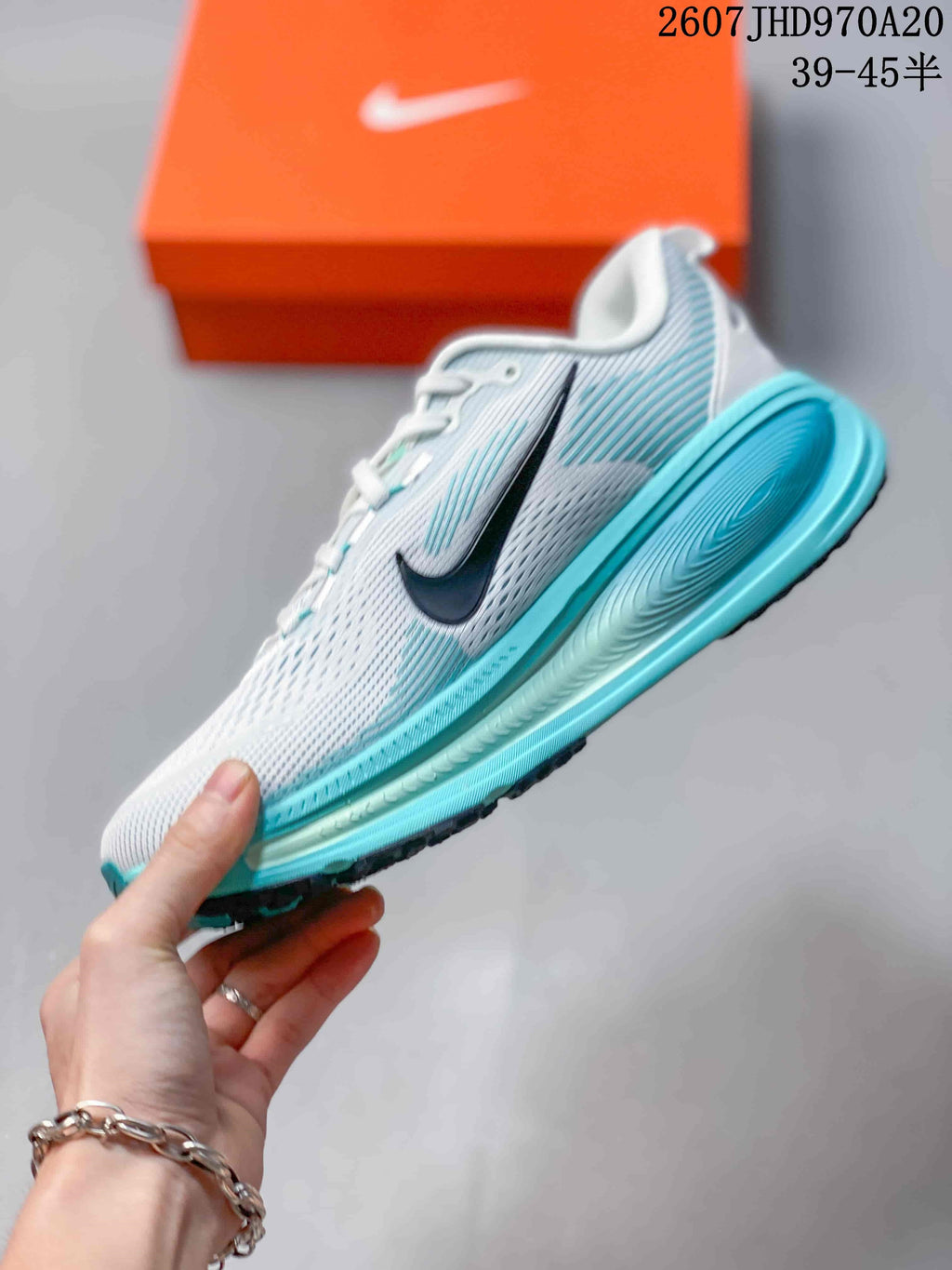 Side view of a white mesh-style sneaker with a black Swoosh, turquoise midsole, and turquoise heel detail.