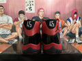 Rear view of black and red high-top sneakers showing the number 45 on both heels and Jumpman-style logos.
