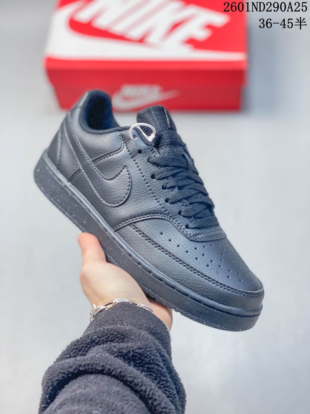 All-black Nike Court Vision Low sneaker with tonal Swoosh, laces and outsole.