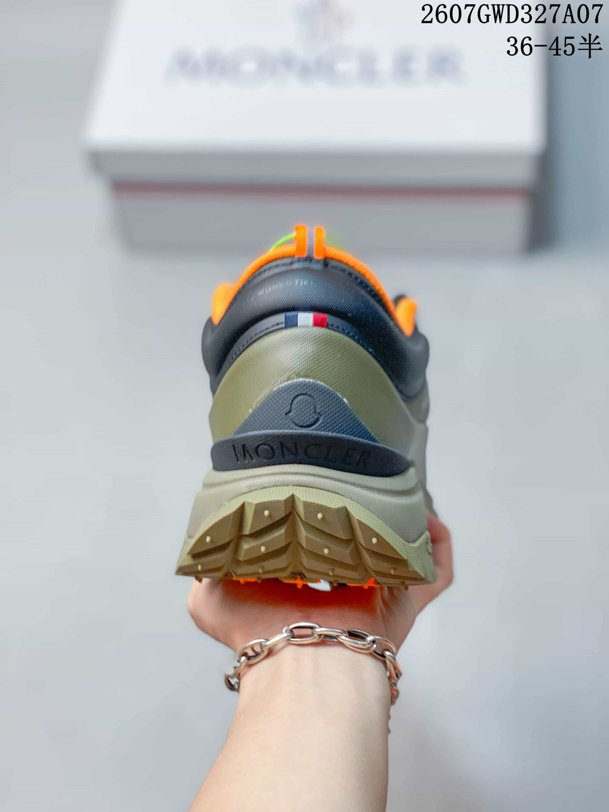 Rear view showing the layered heel construction, orange collar lining, black trim and lugged outsole.