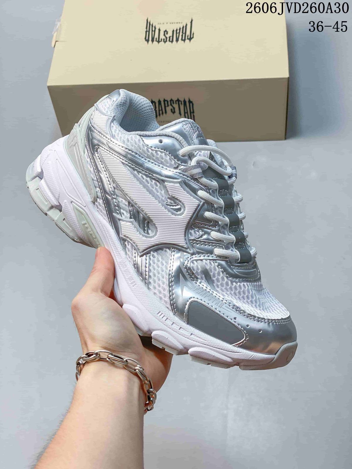 White and silver Trapstar Trispeed 3000 sneaker with reflective-looking accents.