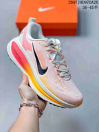 White Nike Structure Plus running sneaker with pink and yellow accents and an orange-tinted midsole section.
