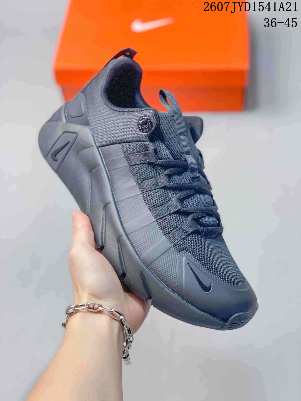 Angled side view of the black sneaker showing the lace-up upper and sculpted sole.