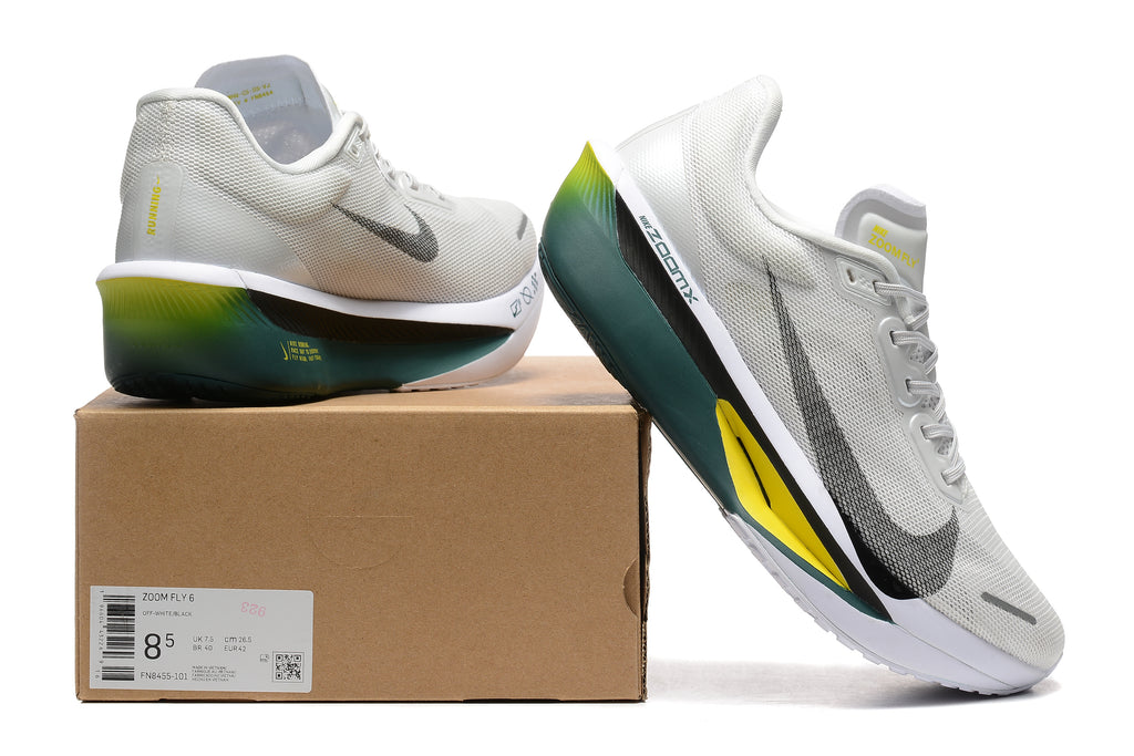 Off-white Nike Zoom Fly 6 shoes with dark green and yellow accents beside a box showing a sample size label