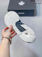 Underside view of the sneaker showing the patterned white outsole and central dark stability section.