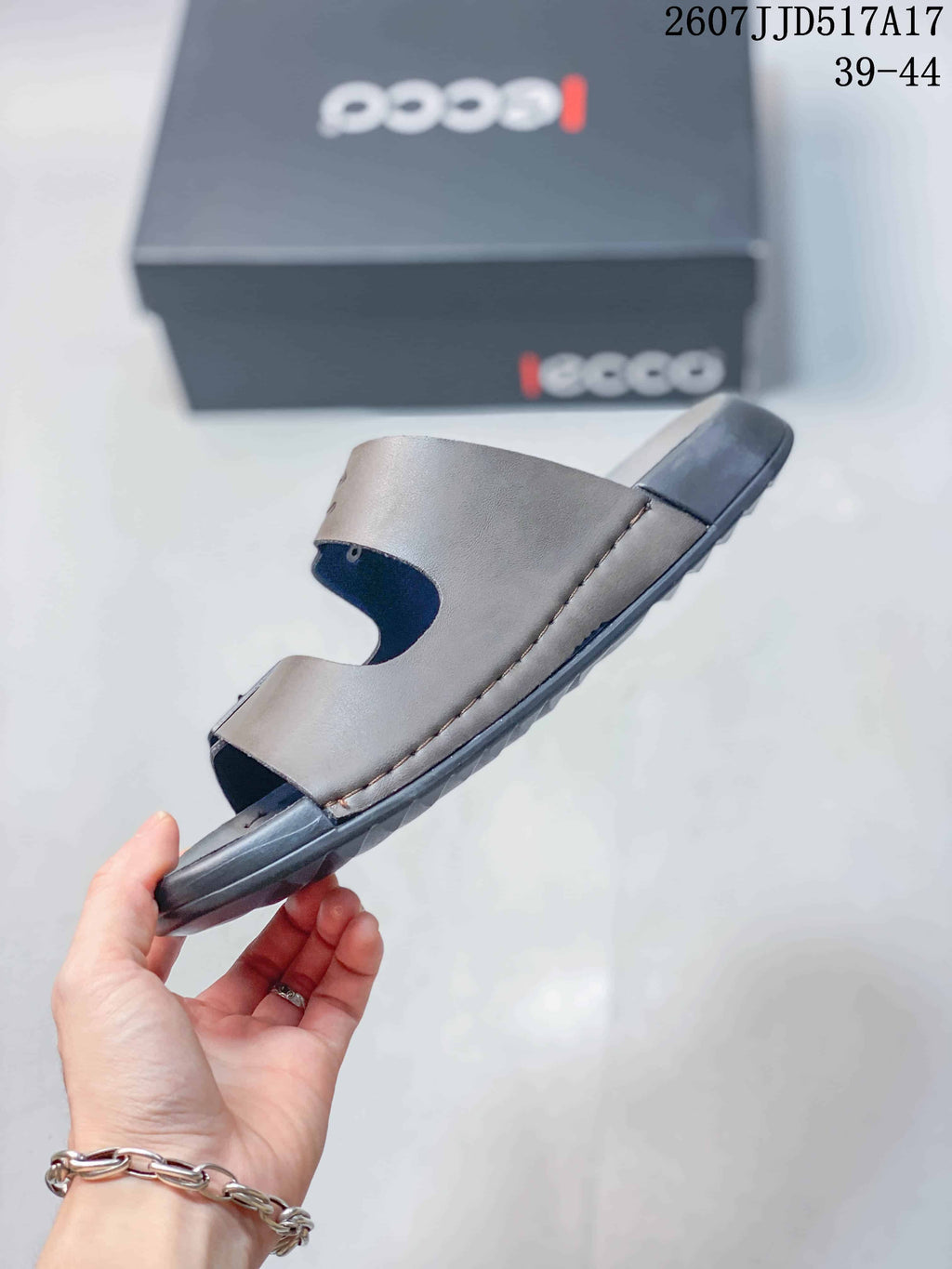 Side view of the taupe-gray ECCO sandal showing the open-toe construction, stitched upper edge and dark outsole.
