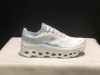 Lateral view showing the light blue side graphic, white upper, and sculpted outsole of the Cloudmonster 1 shoe.