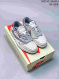 Pair of gray and off-white Nike SB Dunk Low sneakers displayed on a Nike shoebox, with red accents and patterned laces.