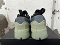 Rear view of the green and grey adidas Dame 9 basketball shoes with black pull tabs.