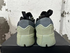 Rear view of the green and grey adidas Dame 9 basketball shoes with black pull tabs.