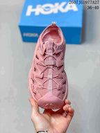Top view of a pink HOKA sandal showing the lace and webbing closure, cutout panels and closed toe; overlay shows size range 36–40.