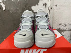 Front view of gray and white Nike sneakers with pink side accents and lace-up closure.
