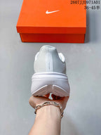 Rear view of the white running shoe with a padded heel and outsole