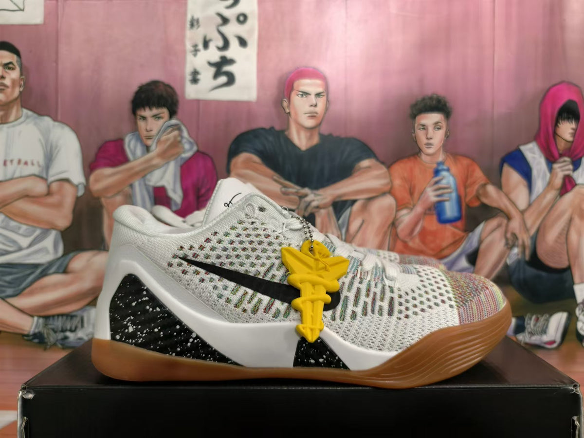 Side view of a white basketball shoe with black logo, speckled heel detail and gum outsole
