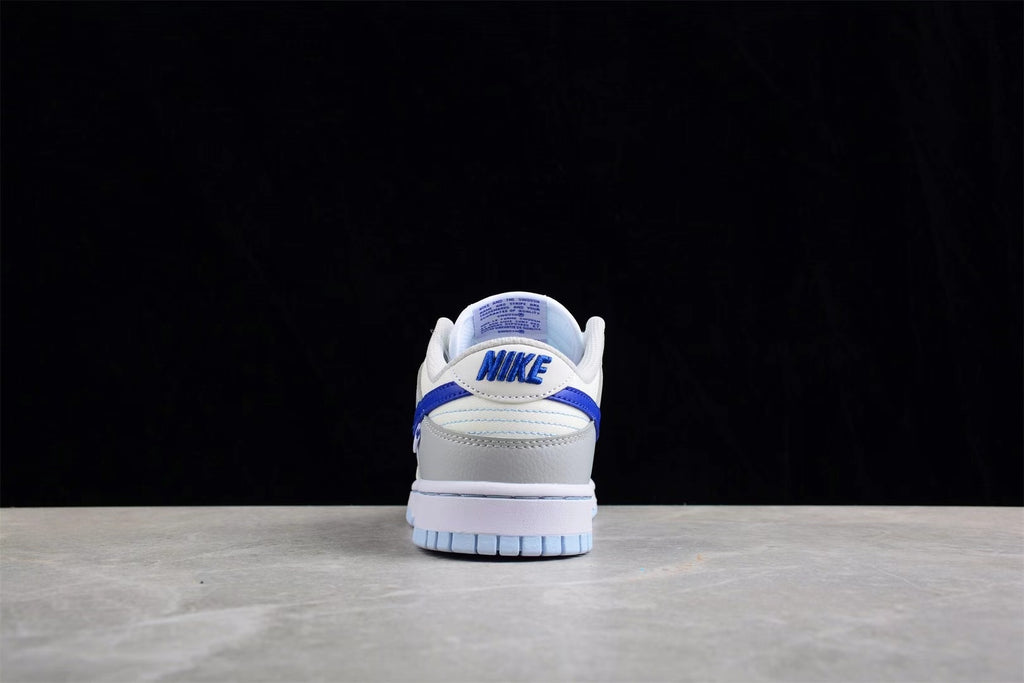 Rear view showing the padded heel, blue branding details, and light blue outsole.