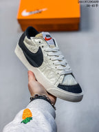Off-white Nike Blazer Low ’77 Jumbo sneaker with dark navy accents and patterned panels