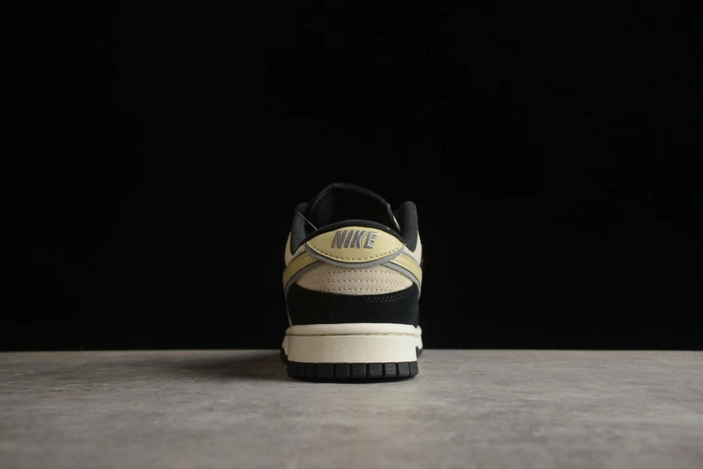 Rear view showing the beige heel accent, visible Nike branding, black heel panel, and layered outsole.