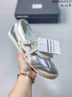 Silver metallic Mary Jane sneaker with white straps, side stripes and a light outsole.