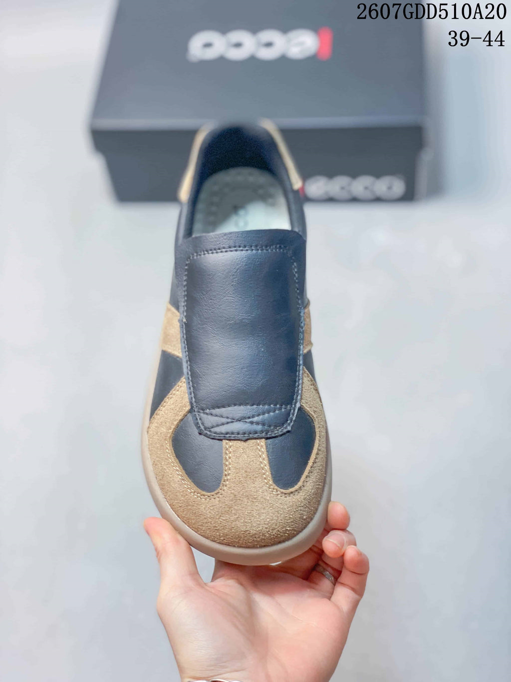 Top view of a navy and tan ECCO sneaker showing the rounded toe and wide front overlay.