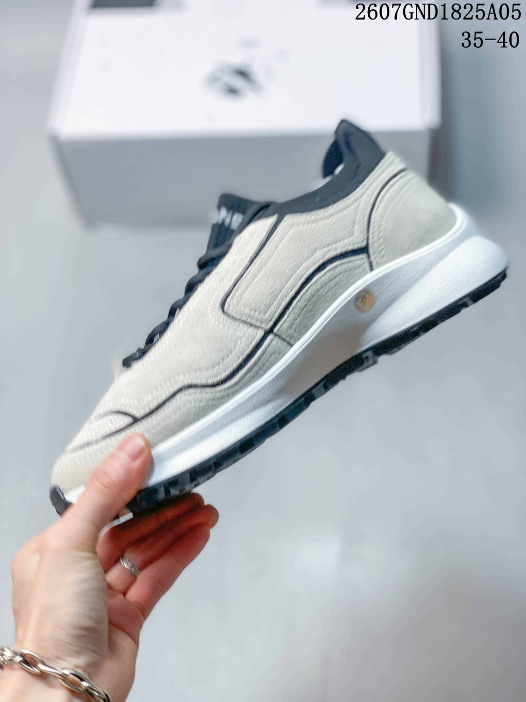 Side profile highlighting the layered upper panels, dark trim, raised white sole, and black outsole.