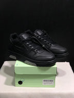 Pair of black low-top sneakers displayed on a light green shoe box; the box label shows size 41.
