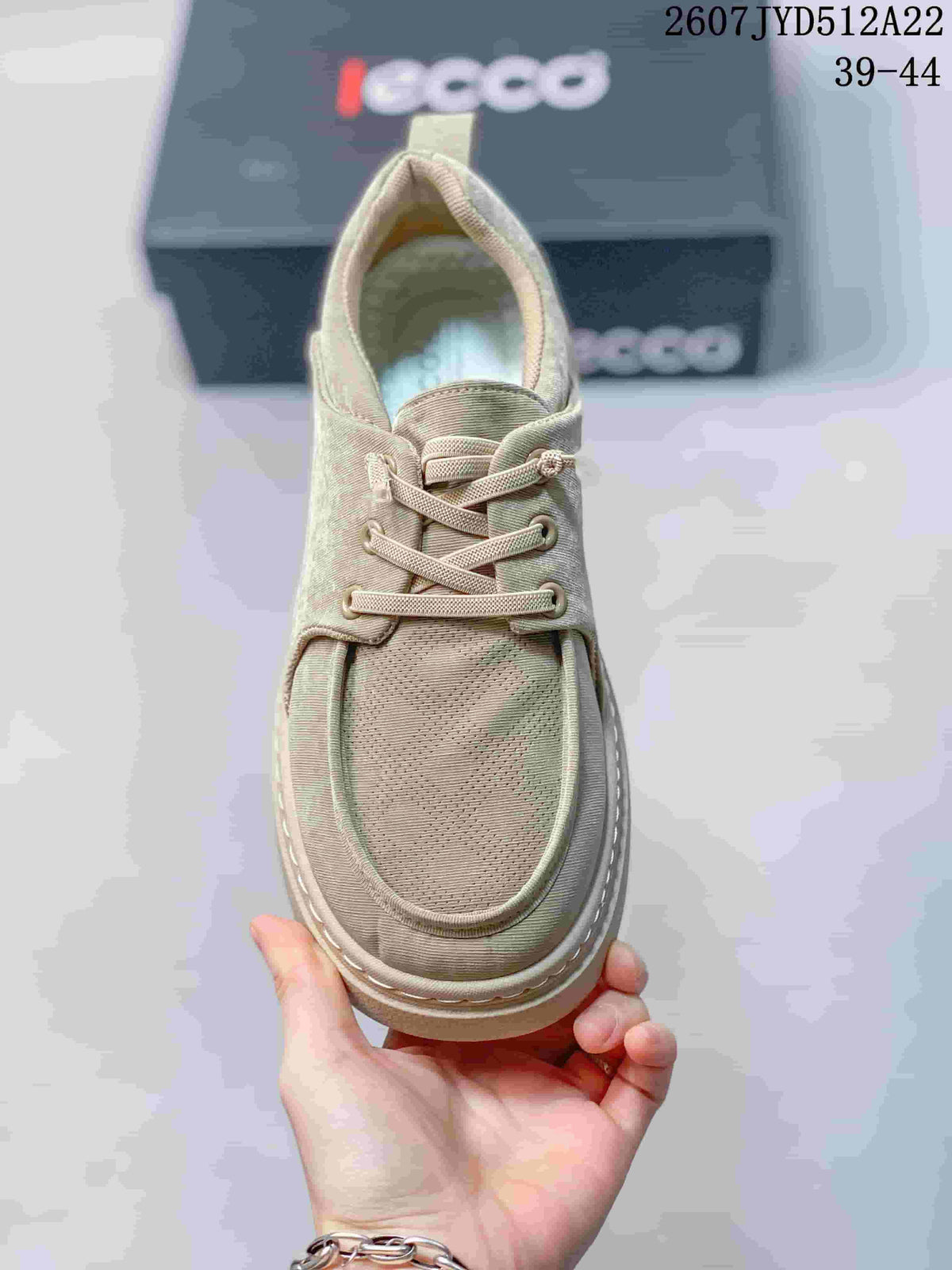 Top view of a beige ECCO sneaker showing the lace-up closure, rounded toe, and layered upper panels.
