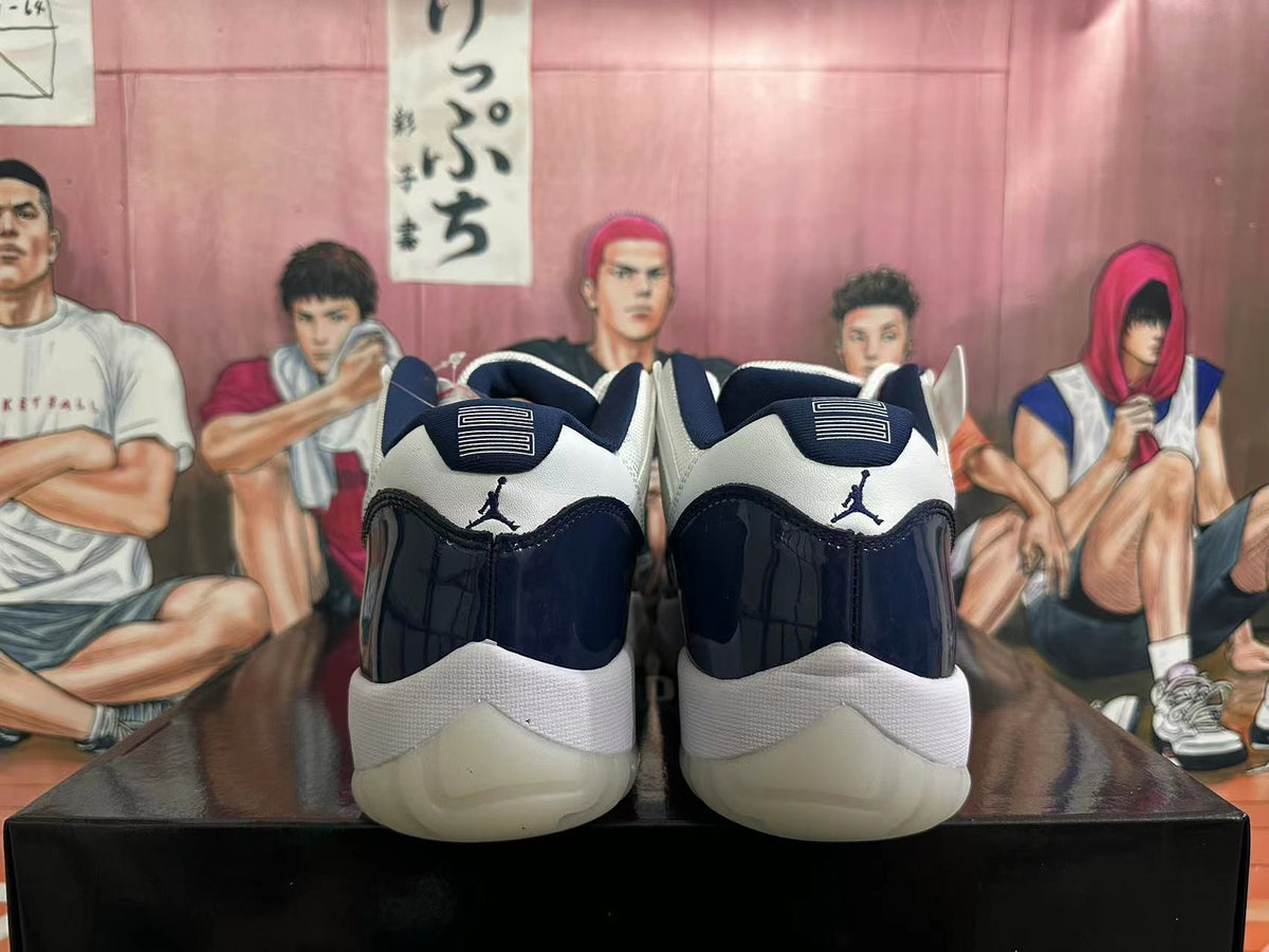 Rear view of navy and white low-top sneakers with Jordan heel logos.