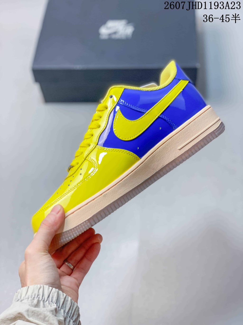 Side view of the yellow and blue low-top sneaker showing the yellow Swoosh and layered midsole.
