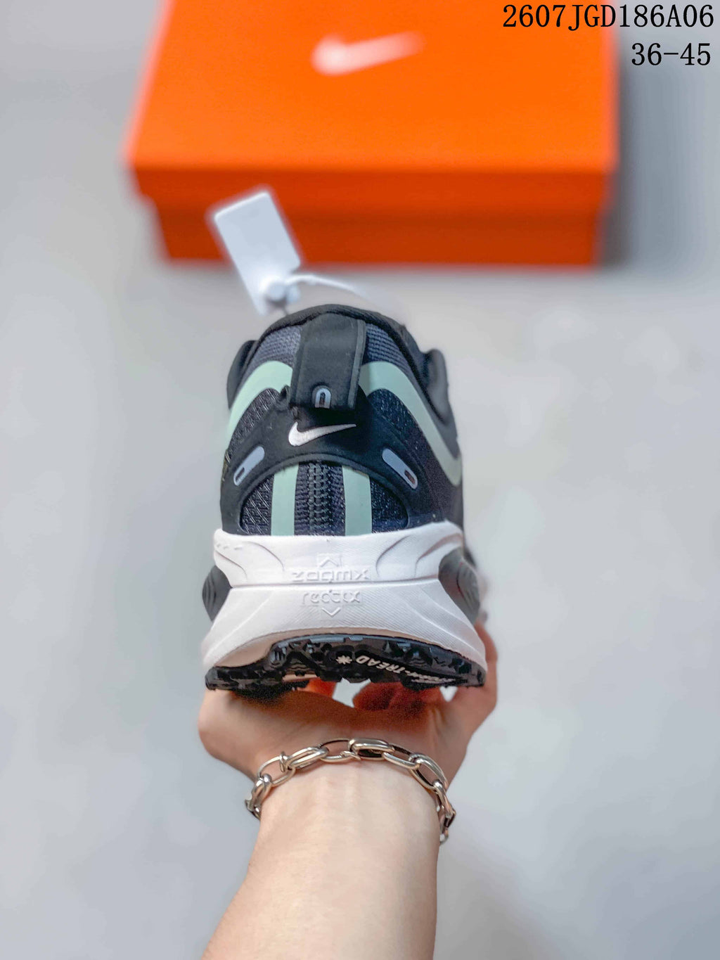 Rear view of the shoe showing the padded heel, mint accent strips, white midsole, and black outsole.
