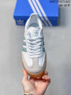 Top view showing white laces, the adidas tongue label, and gray toe panels.