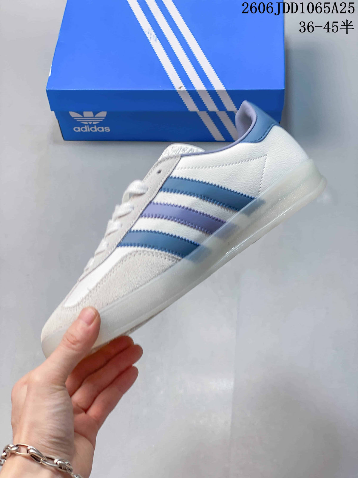 Side profile showing the white upper, blue and lavender stripes, padded collar, and translucent sole.