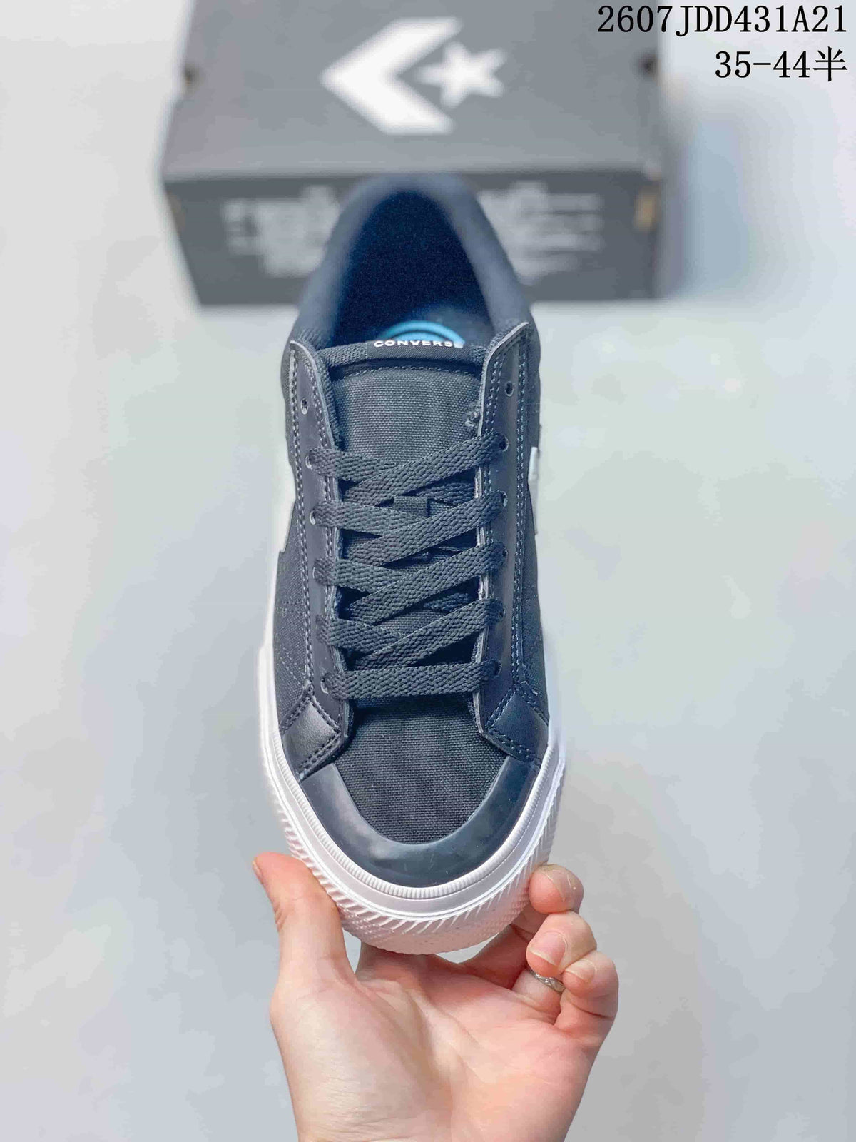 Top view of the navy sneaker showing flat laces, textile-like upper panels, and a rounded toe.