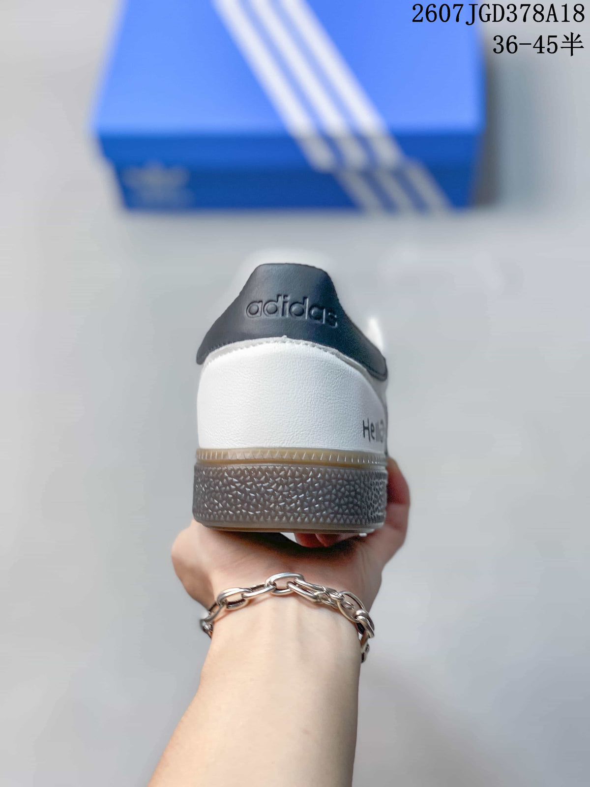 Rear view showing the black heel tab, white heel panel, and textured outsole.