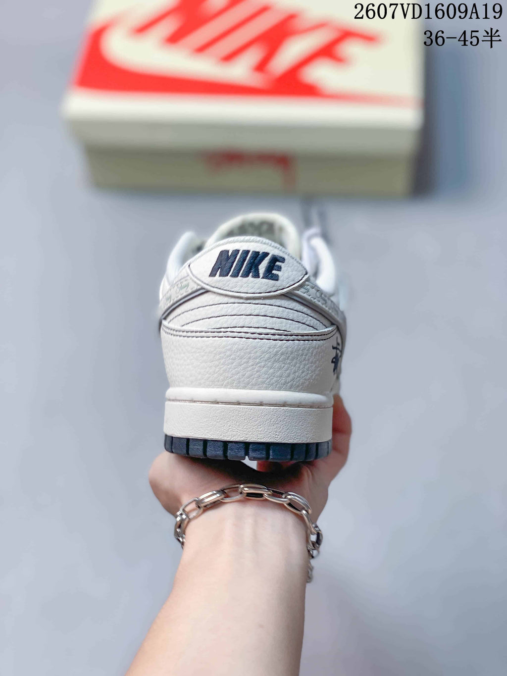 Rear view showing the white heel panel, layered stitching and dark outsole edge.