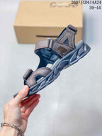 Side view of the sandal showing its layered adjustable straps, open construction, and textured outsole.