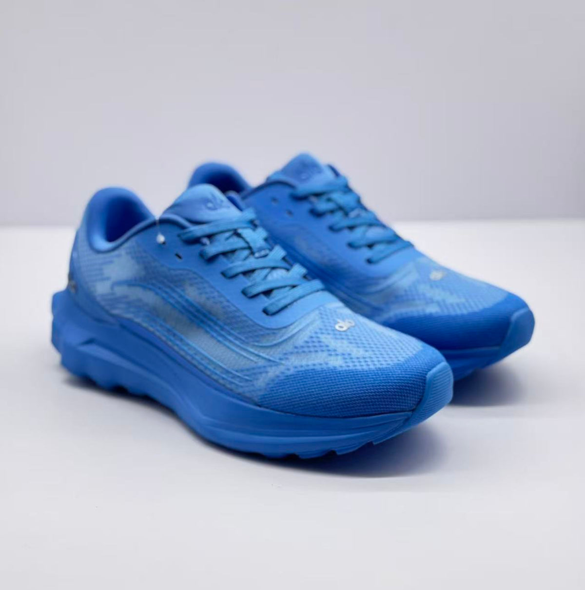 Pair of blue Alo Runner sneakers shown from a front three-quarter angle.